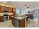 Open kitchen with stainless steel appliances, granite countertops, and an adjacent living area at 18026 W Carmen Dr, Surprise, AZ 85388