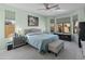 Calm main bedroom with neutral tones, large bed, ceiling fan, and ample natural light from the windows at 18026 W Carmen Dr, Surprise, AZ 85388