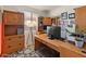 This home office features wood cabinets, lots of storage, and natural light at 18026 W Carmen Dr, Surprise, AZ 85388