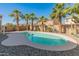 Backyard swimming pool with desert landscaping and tall palm trees, perfect for relaxing at 18026 W Carmen Dr, Surprise, AZ 85388