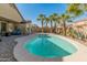 Inviting backyard pool surrounded by lush palm trees, perfect for relaxing or entertaining guests at 18026 W Carmen Dr, Surprise, AZ 85388