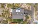 Overhead drone shot of a desert home showing the roof, backyard, surrounding walls and lush landscaping at 1844 E Cinnabar Ave, Phoenix, AZ 85020