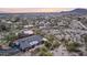 Aerial view of a desert home, showcasing the backyard, patio, and lush greenery with a sunset view at 1844 E Cinnabar Ave, Phoenix, AZ 85020