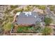 Birds eye view of a desert home showing the roof, backyard, surrounding walls and lush landscaping at 1844 E Cinnabar Ave, Phoenix, AZ 85020