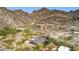 Aerial view of a desert home nestled in a mountain landscape with a lush backyard and desert landscaping at 1844 E Cinnabar Ave, Phoenix, AZ 85020