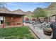 Expansive backyard with brick patio, multiple seating areas, and a serene mountain backdrop for outdoor gatherings at 1844 E Cinnabar Ave, Phoenix, AZ 85020