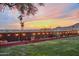 Backyard featuring a manicured lawn, planter boxes, mountain views, and a metal fence with string lights at 1844 E Cinnabar Ave, Phoenix, AZ 85020