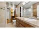 Bathroom with granite countertops, wood cabinets, and full vanity mirror at 1844 E Cinnabar Ave, Phoenix, AZ 85020