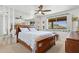 Bedroom with a mirrored wall, fan, large bed, and a window with a view to the desert at 1844 E Cinnabar Ave, Phoenix, AZ 85020