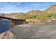 Long driveway leading to a desert home, garage, and hillside surroundings at 1844 E Cinnabar Ave, Phoenix, AZ 85020