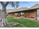 Charming brick home featuring a covered patio, mountain views, and colorful potted plants at 1844 E Cinnabar Ave, Phoenix, AZ 85020