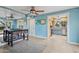 Charming living area with tile floors, blue walls, ceiling fan, and a peek into the kitchen, blending style and function at 1844 E Cinnabar Ave, Phoenix, AZ 85020