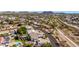 Stunning aerial view of a neighborhood with lush greenery and majestic mountains in the distance at 18468 N 63Rd Dr, Glendale, AZ 85308