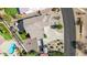 An overhead view of a property with a lush backyard, firepit, and a sparkling swimming pool at 18468 N 63Rd Dr, Glendale, AZ 85308