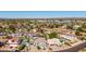 Expansive aerial perspective showcasing a vibrant residential neighborhood with views of distant mountains at 18468 N 63Rd Dr, Glendale, AZ 85308