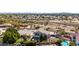 High aerial shot of the backyard with mature landscaping, grass lawn, and community landscape at 18468 N 63Rd Dr, Glendale, AZ 85308