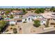 Expansive aerial view of the home's front exterior, showcasing the driveway and lush landscaping at 18468 N 63Rd Dr, Glendale, AZ 85308