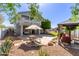 Spacious backyard with a gazebo, dining area, lush trees, and a covered patio at 18468 N 63Rd Dr, Glendale, AZ 85308