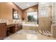 Relaxing bathroom with a soaking tub, separate shower, and double vanity with lots of light at 18468 N 63Rd Dr, Glendale, AZ 85308