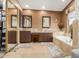 Beautiful bathroom featuring dual sinks, granite counters, a soaking tub, and neutral tones at 18468 N 63Rd Dr, Glendale, AZ 85308