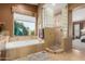 Tranquil bathroom featuring a soaking tub, a shower, and a vanity with granite counters at 18468 N 63Rd Dr, Glendale, AZ 85308