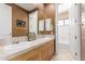 A bathroom features a double sink vanity with framed mirror, and separate toilet and bath behind an open door at 18468 N 63Rd Dr, Glendale, AZ 85308