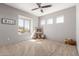 Bright bedroom with natural light, a ceiling fan, and neutral walls for a relaxing space at 18468 N 63Rd Dr, Glendale, AZ 85308