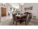 Dining room with a large table, chandelier, and view into the living room at 18468 N 63Rd Dr, Glendale, AZ 85308