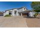 Spacious home featuring a wide driveway leading to a three-car garage at 18468 N 63Rd Dr, Glendale, AZ 85308