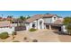 An aerial shot of the home's front facade highlighting the roof, garage, and mature foliage at 18468 N 63Rd Dr, Glendale, AZ 85308