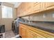 Functional laundry room featuring ample cabinet space, a utility sink, and modern washer/dryer units at 18468 N 63Rd Dr, Glendale, AZ 85308