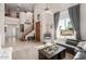 Bright, airy living room featuring tile floors, a staircase and large windows at 18468 N 63Rd Dr, Glendale, AZ 85308