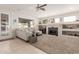 Bright and spacious living room featuring a decorative fireplace and large windows at 18468 N 63Rd Dr, Glendale, AZ 85308