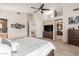 Bright primary bedroom showcasing the ensuite bath, a ceiling fan, and natural light at 18468 N 63Rd Dr, Glendale, AZ 85308