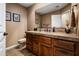 Stylish bathroom featuring a wood vanity with tiled countertop and decorative framed art pieces on the wall at 18944 E Amethyst Dr, Rio Verde, AZ 85263