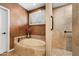 A view of the tub and shower area in a bathroom with tile accents at 18944 E Amethyst Dr, Rio Verde, AZ 85263