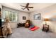 Cozy bedroom showcasing a ceiling fan, window with shutters, and plush carpeting for ultimate comfort at 18944 E Amethyst Dr, Rio Verde, AZ 85263