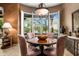 Elegant dining room with bay windows and contemporary lighting at 18944 E Amethyst Dr, Rio Verde, AZ 85263