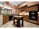 A view of the kitchen showcases tile floors, wooden cabinets, and granite countertops at 18944 E Amethyst Dr, Rio Verde, AZ 85263