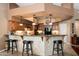 Kitchen bar with tile accents, granite countertops, pendant lights, and wooden cabinetry at 18944 E Amethyst Dr, Rio Verde, AZ 85263