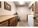 Functional laundry room featuring ample counter space, built-in cabinets, and a modern washer and dryer at 18944 E Amethyst Dr, Rio Verde, AZ 85263