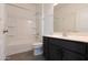 Bathroom with bathtub, shower, sink, modern dark-wood cabinets, and toilet at 19975 W Glenrosa Ave, Litchfield Park, AZ 85340