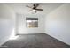 Bedroom with neutral carpet, a ceiling fan and a window at 19975 W Glenrosa Ave, Litchfield Park, AZ 85340