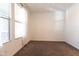 Bright bedroom with large window, blinds, neutral carpet, and fresh, white walls at 19975 W Glenrosa Ave, Litchfield Park, AZ 85340