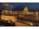 Stunning night view of Verrado Golf Club with fountain and illuminated palm trees at 19975 W Glenrosa Ave, Litchfield Park, AZ 85340