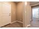 Hallway with tile flooring, white walls, entry door, and access to other areas at 19975 W Glenrosa Ave, Litchfield Park, AZ 85340