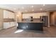 Modern kitchen with white cabinets, stainless steel appliances, a dark center island, and granite countertops at 19975 W Glenrosa Ave, Litchfield Park, AZ 85340