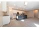 Open kitchen with white cabinets, a dark center island, and stainless steel appliances offers a seamless flow for cooking at 19975 W Glenrosa Ave, Litchfield Park, AZ 85340