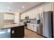 Well-lit kitchen features a large island, stainless steel appliances, granite countertops, and classic white cabinetry at 19975 W Glenrosa Ave, Litchfield Park, AZ 85340