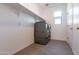 Laundry room with gray washer and dryer and tile floors at 19975 W Glenrosa Ave, Litchfield Park, AZ 85340